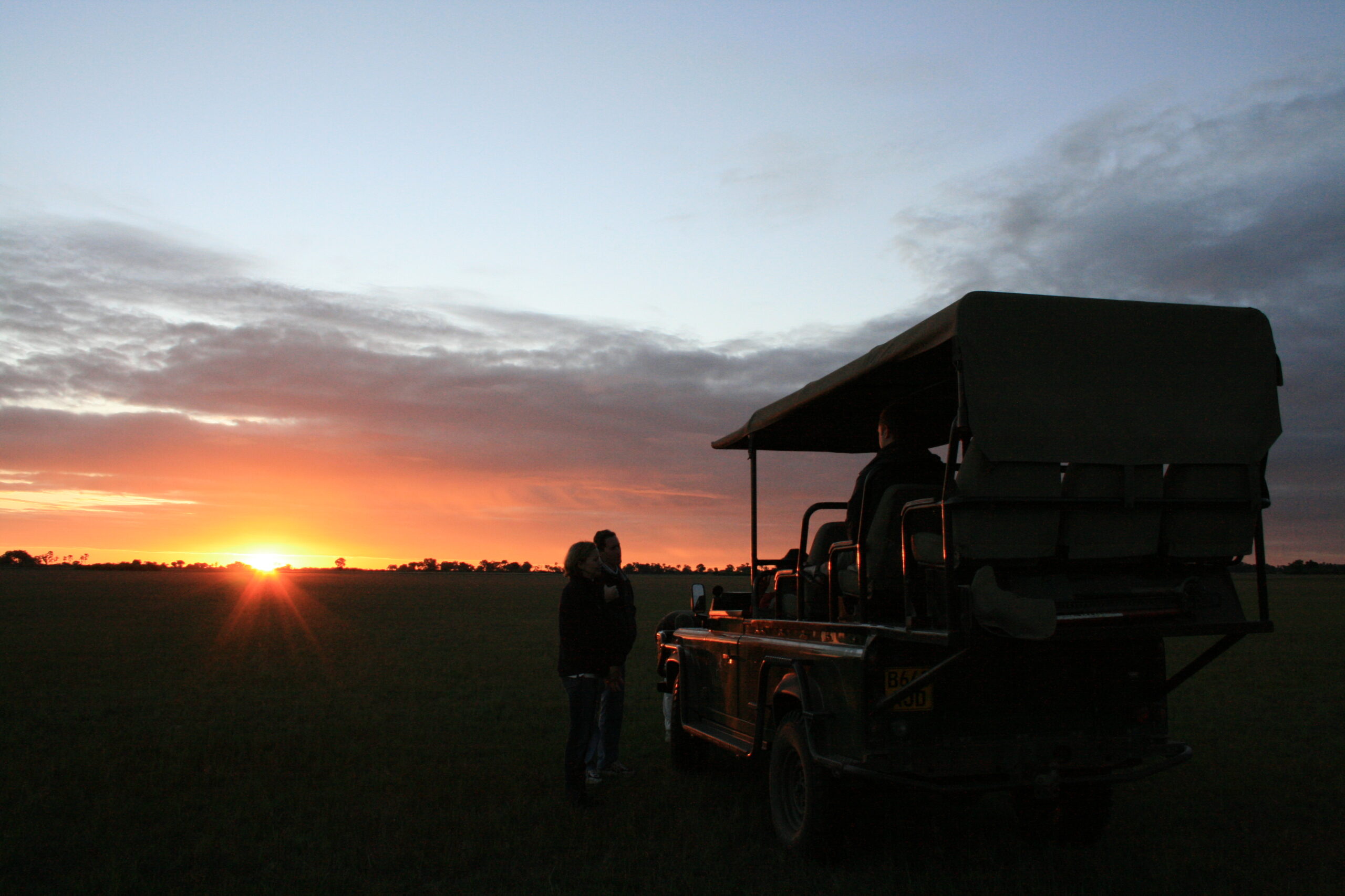 The sun sets over our Land Rover on our final day in Botswana.