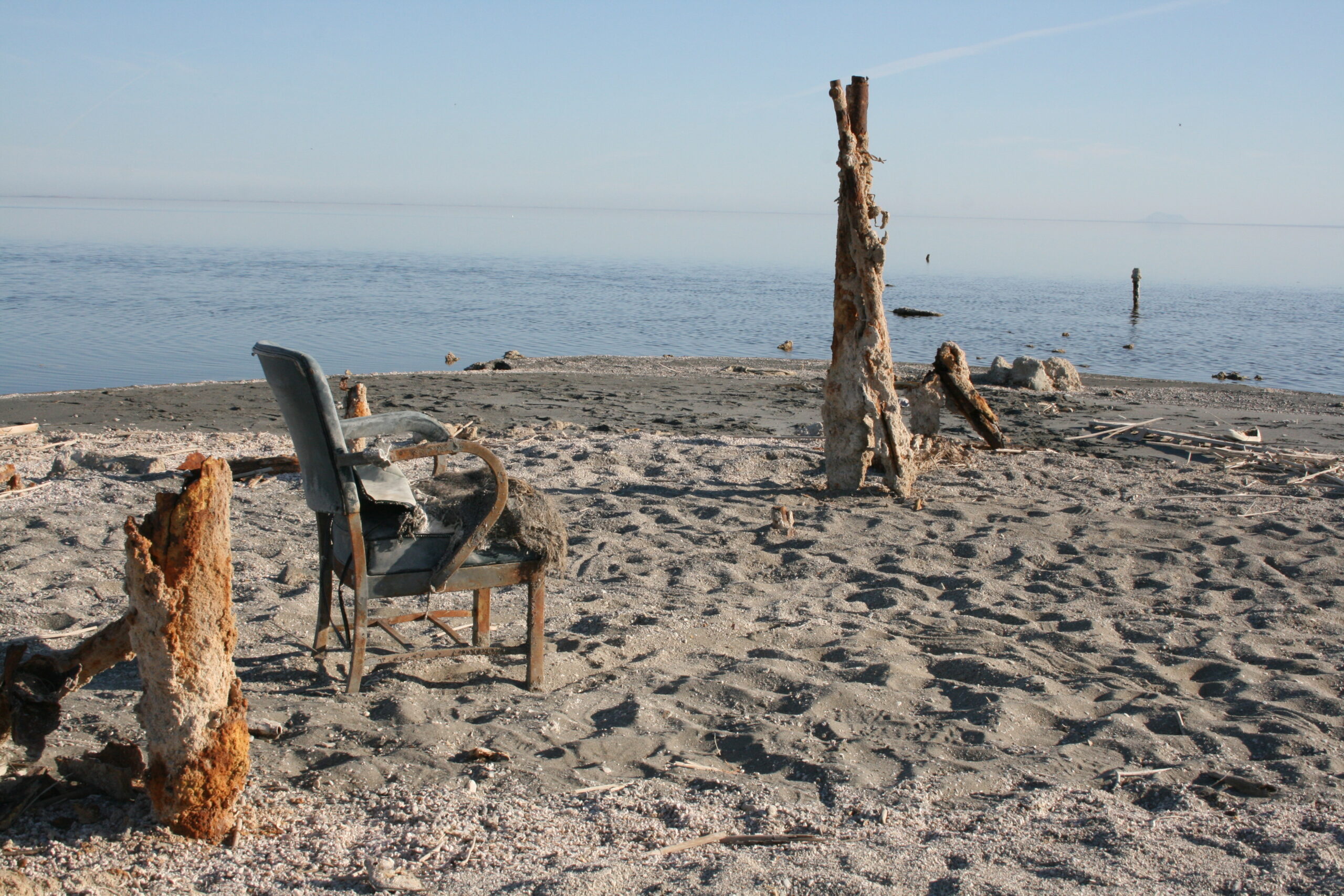 An abandoned chair sits on the shore of the Salton Sea