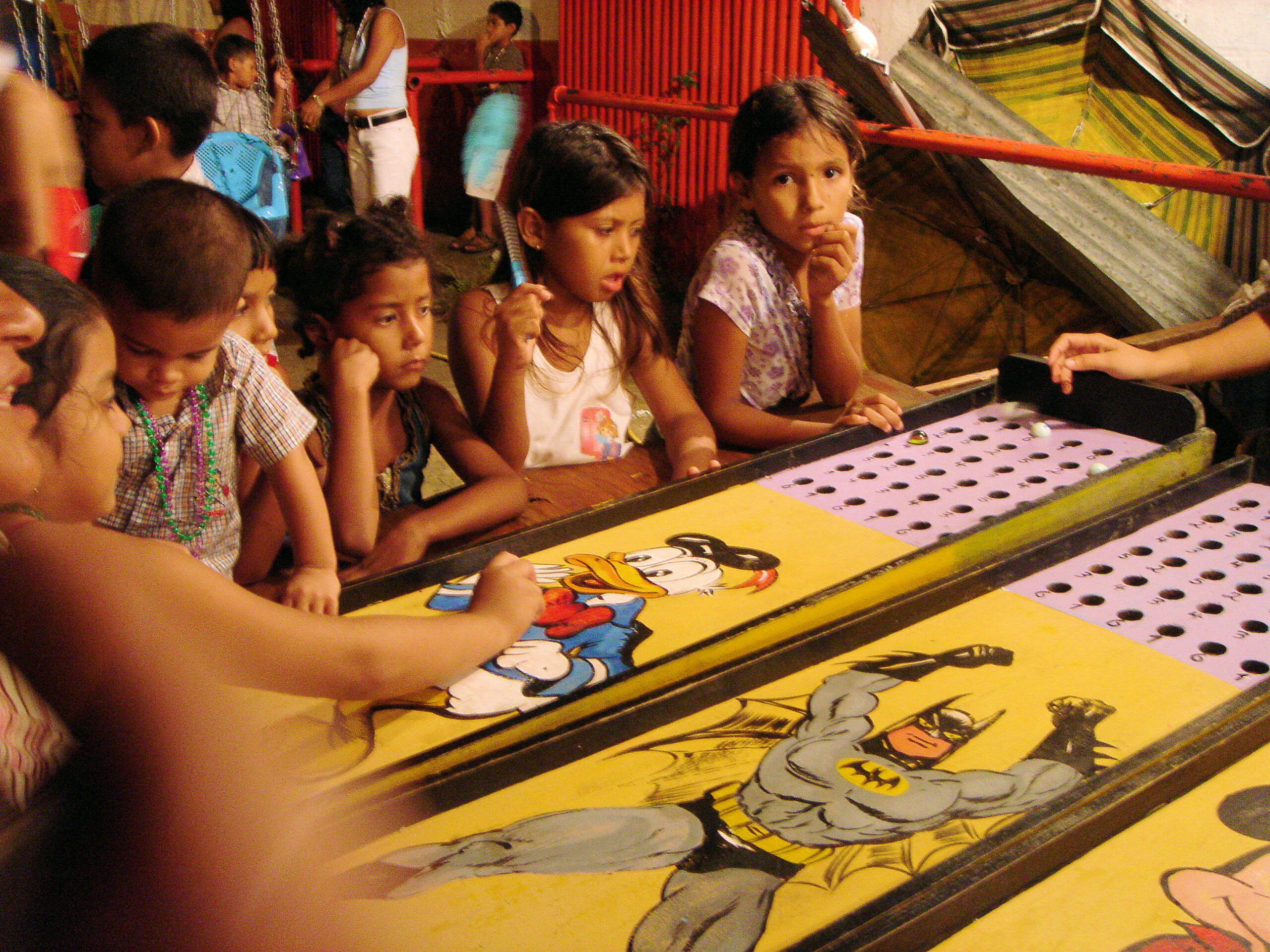 Children watch carnival games at a patron saint festival in Tela, Honduras.