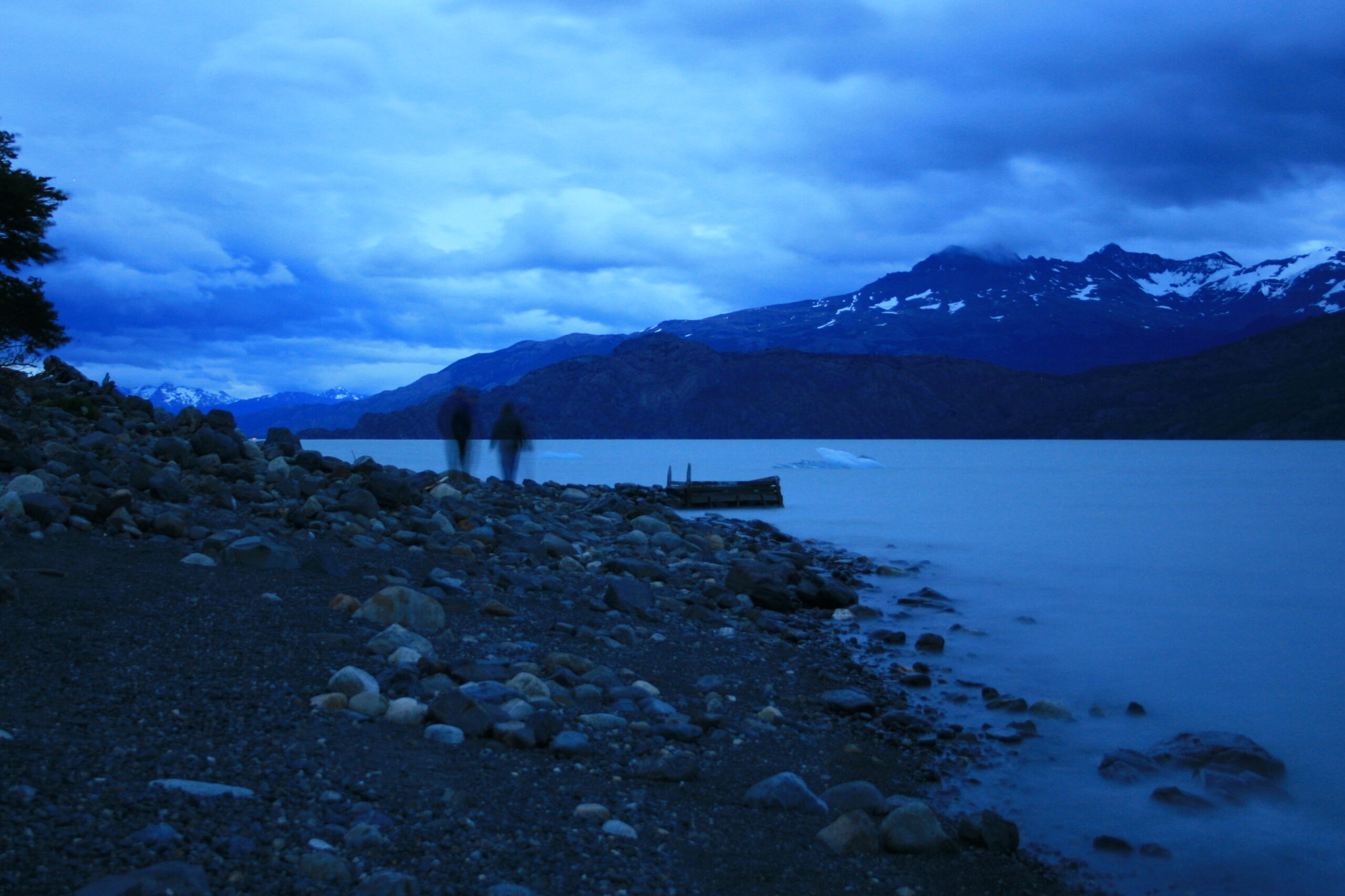 Hank and Brittany walk along the shore of Lago Grey at dusk. (photo by Brian Leukart)