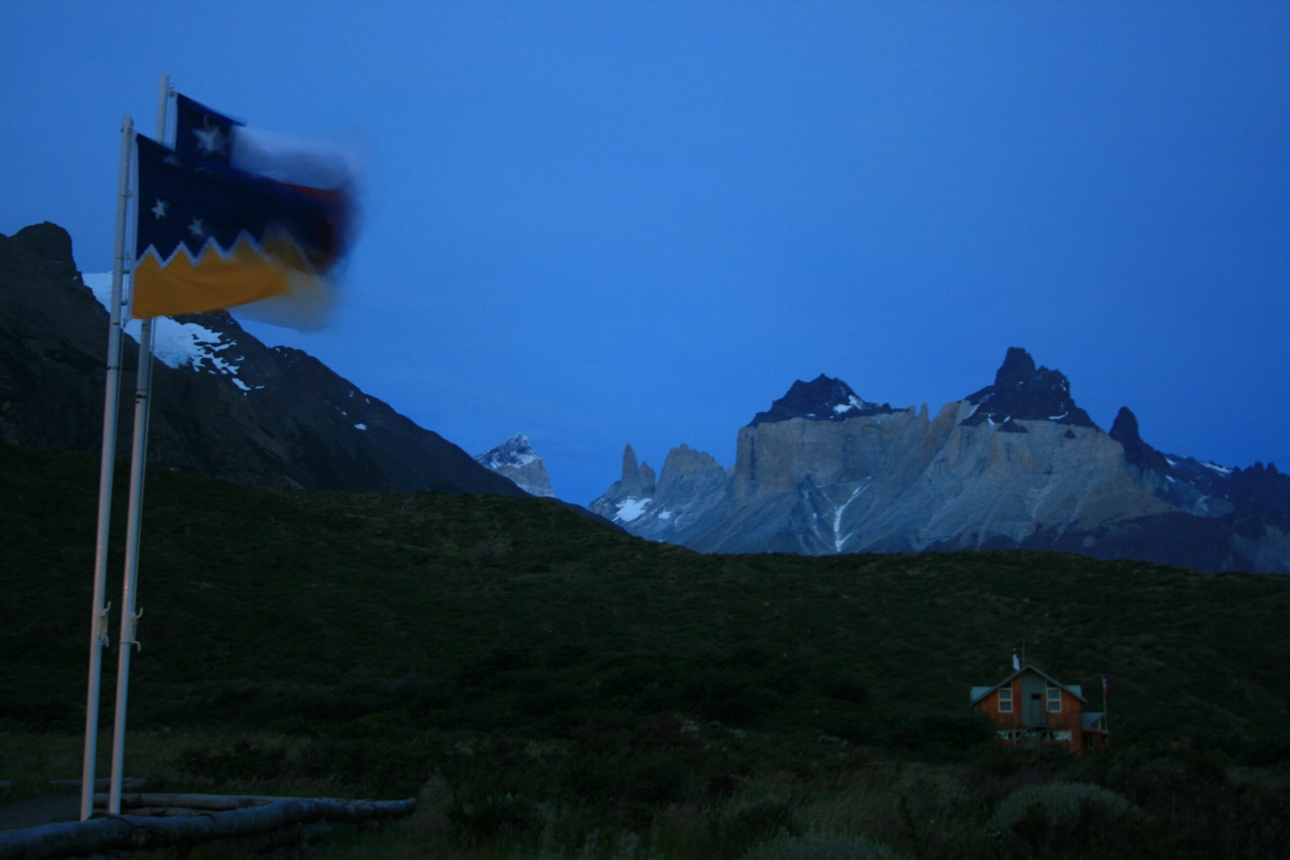 Chilean flags wave at dusk near Paine Grande in Torres del Paine National Park. (photo by Brian Leukart)