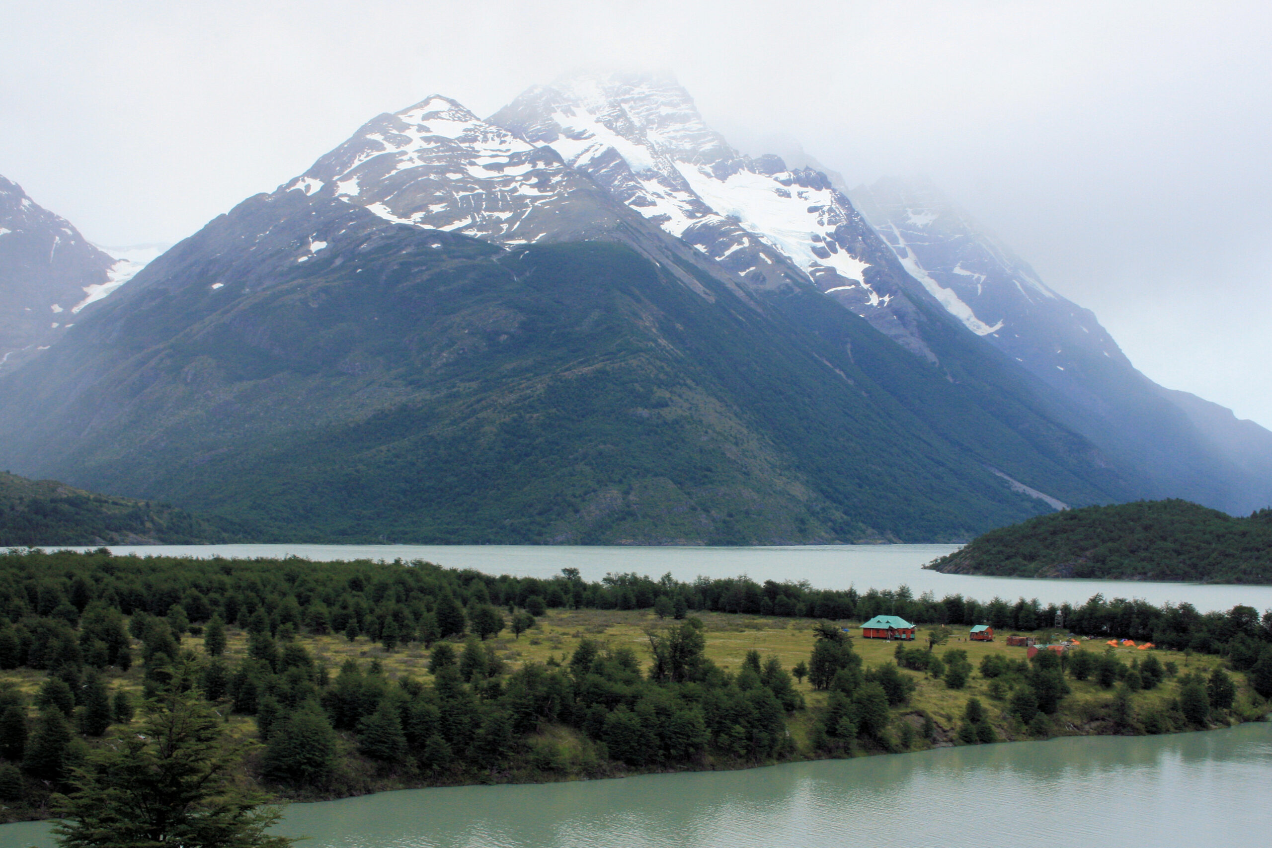 Mountains shrouded in fog behind Refugio Lago Paine in Chilean Patagonia's Torres del Paine National Park.