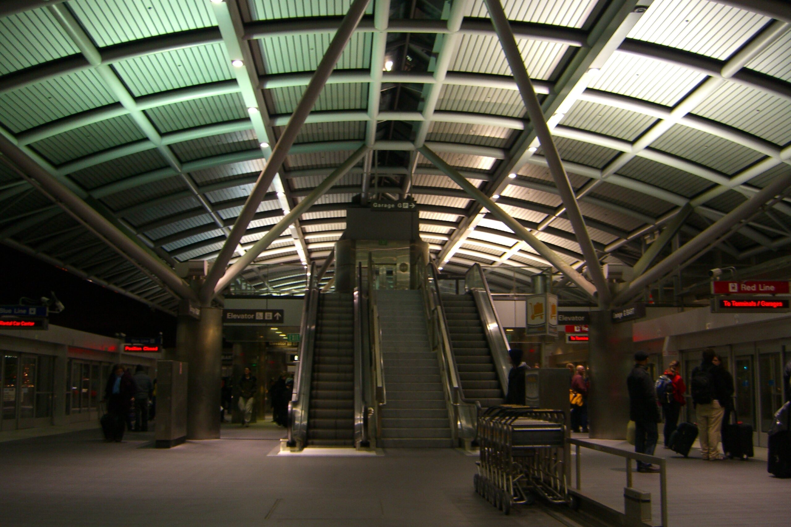 Signs for the Blue Line (left) and Red Line (right) in an AirTrain terminal at the San Francisco International Airport.