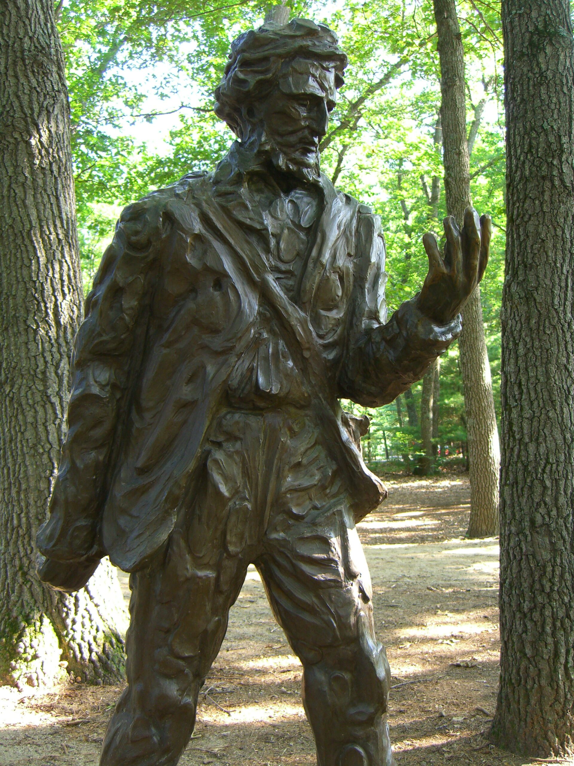 A statue of Henry David Thoreau stands near Walden Pond.