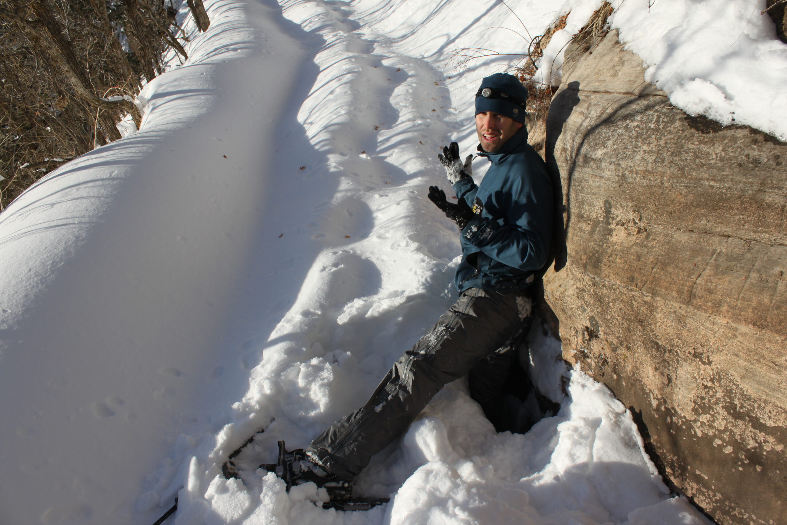 Brian reluctantly demonstrates the depth of the snow on the Grand Canyon's North Kaibab Trail.  Note that he is wearing snowshoes on both feet.