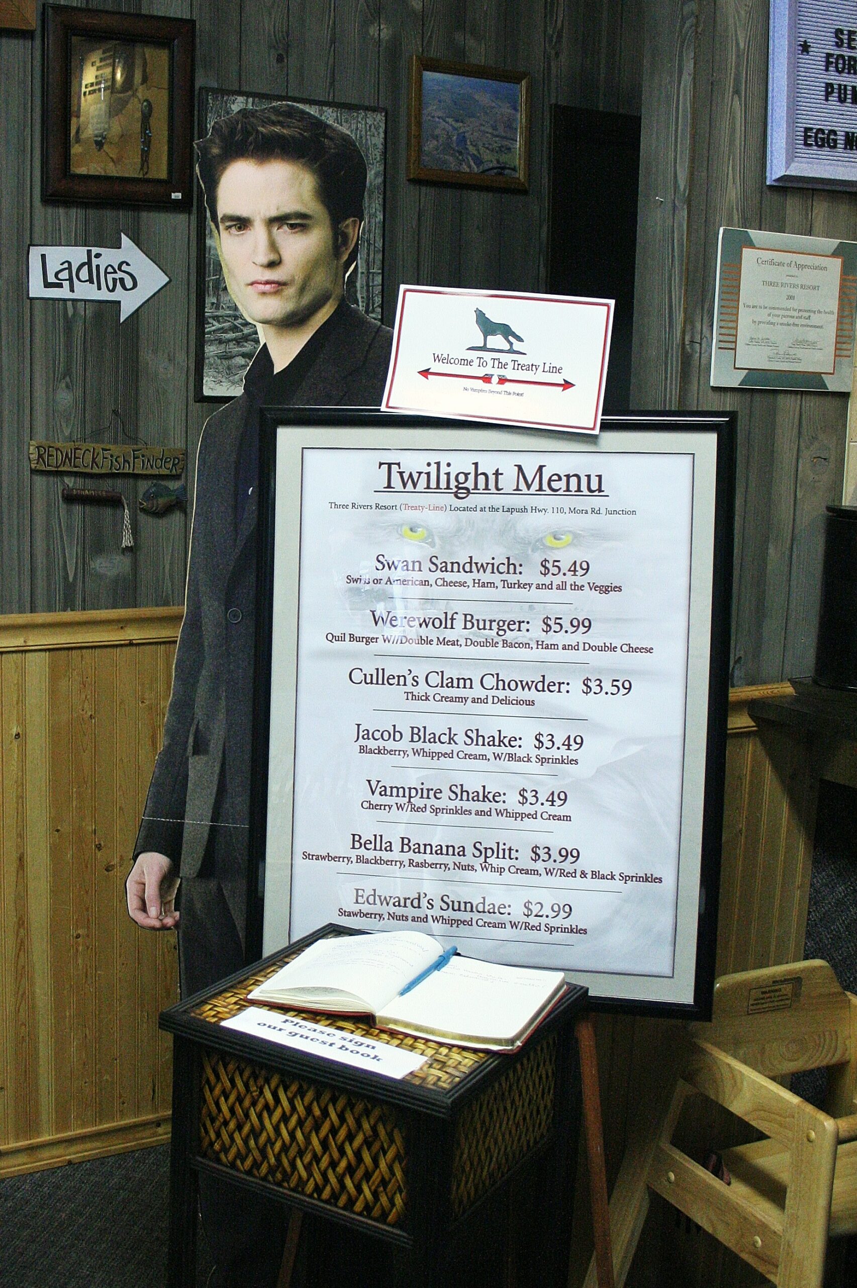 A cardboard cutout of Edward Cullen (a.k.a. Robert Pattinson) stands behind a restaurant menu in Forks, Washington.
