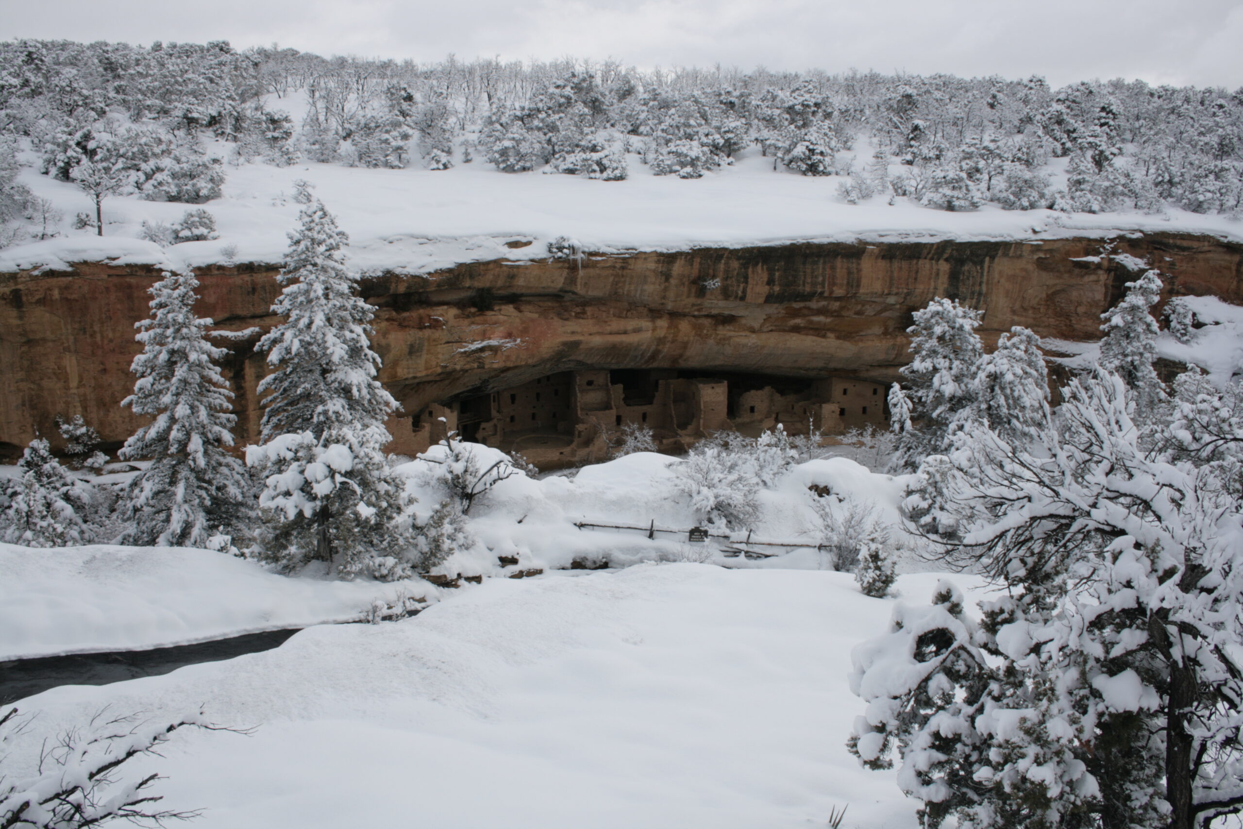 Spruce Tree House sits below a snow-covered cliff in Mesa Verde National Park.