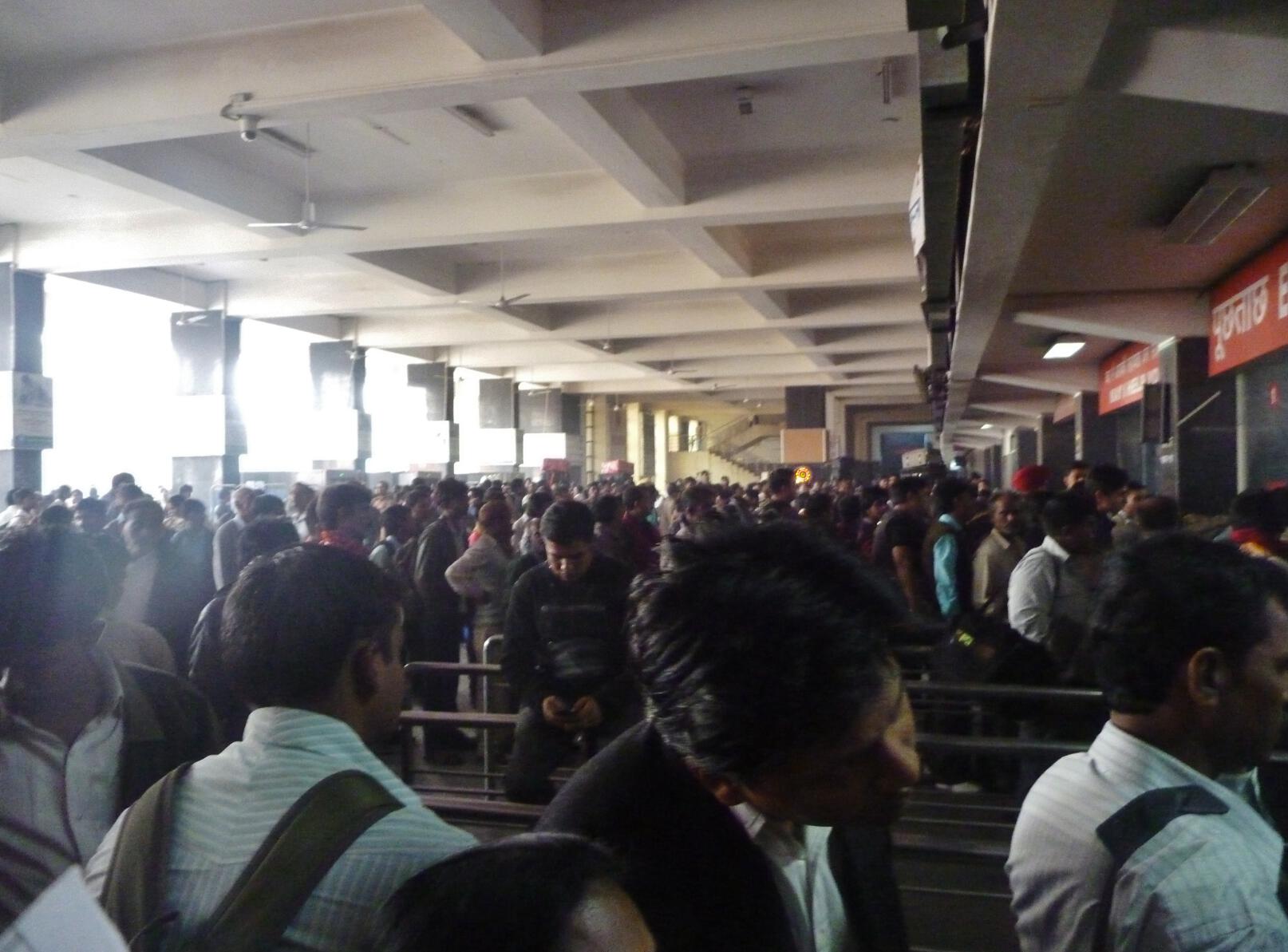 Passengers flood the New Delhi train station.