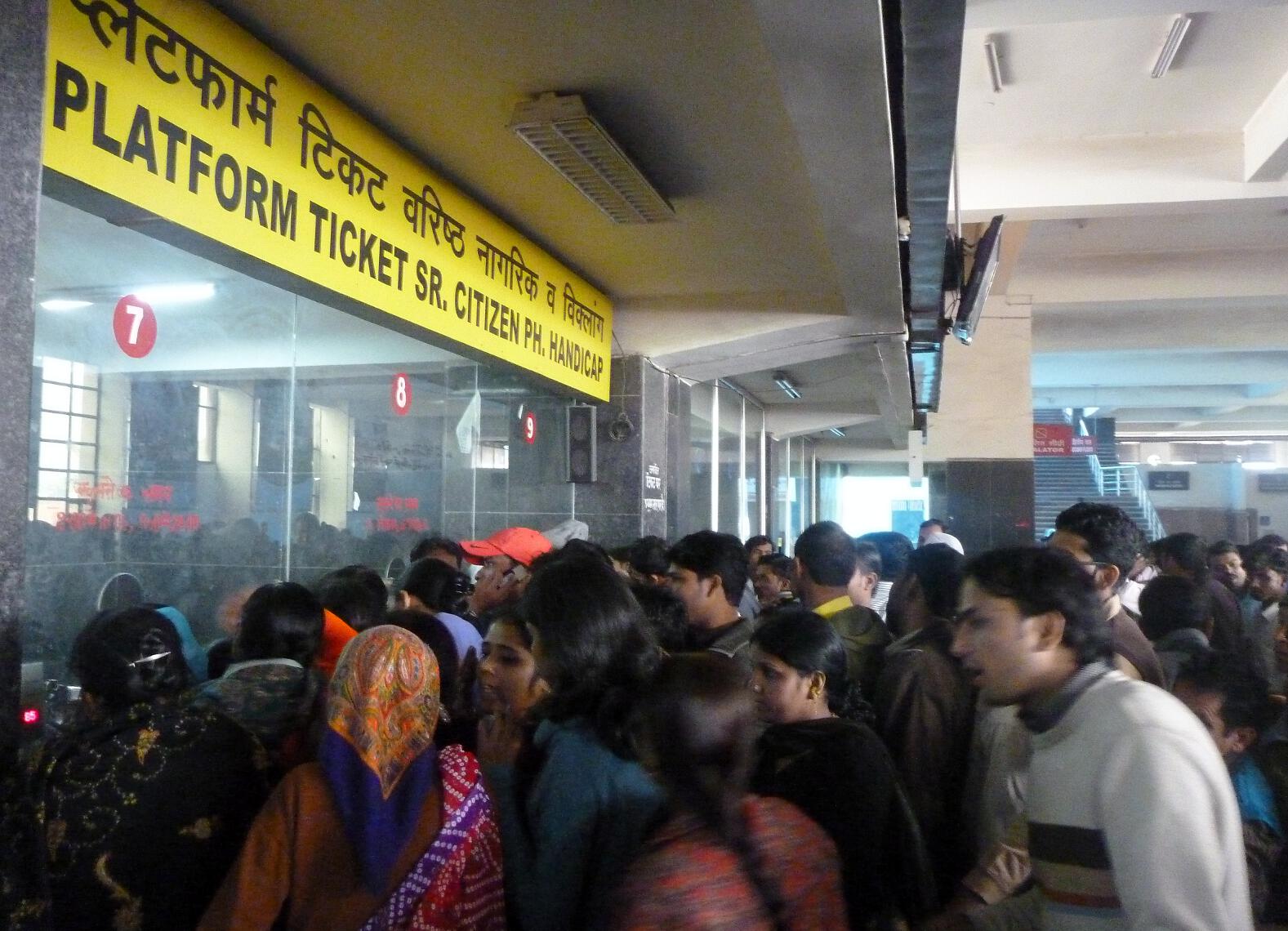 Customers clamor to buy tickets at the New Delhi train station. 