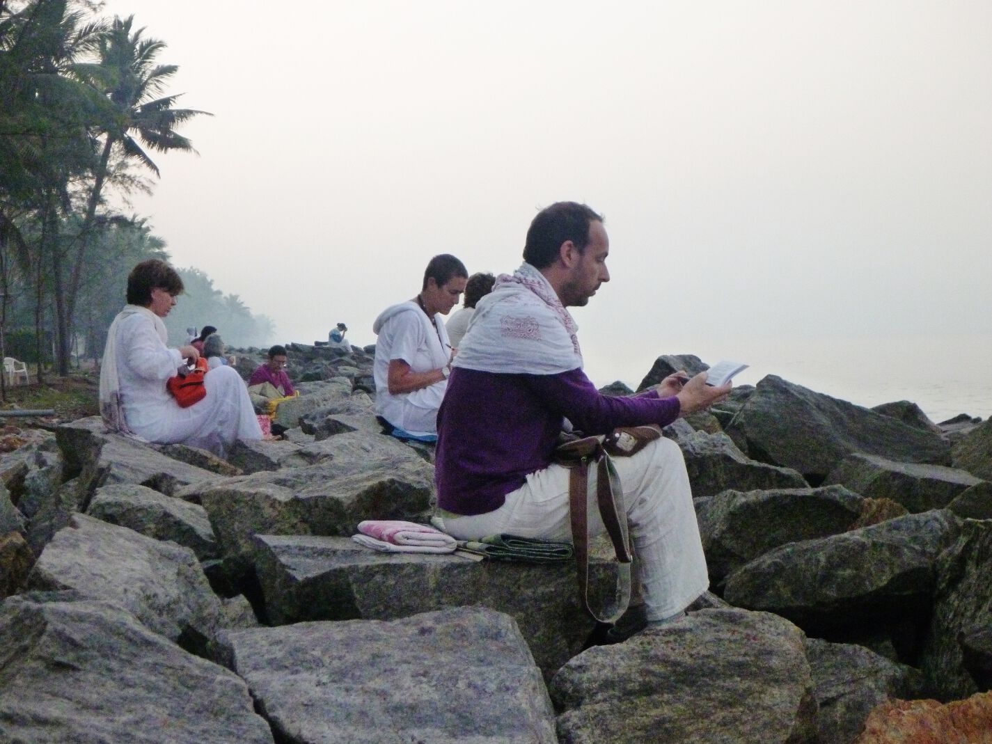 Devotees meditate on a beach in Amritapuri, India.