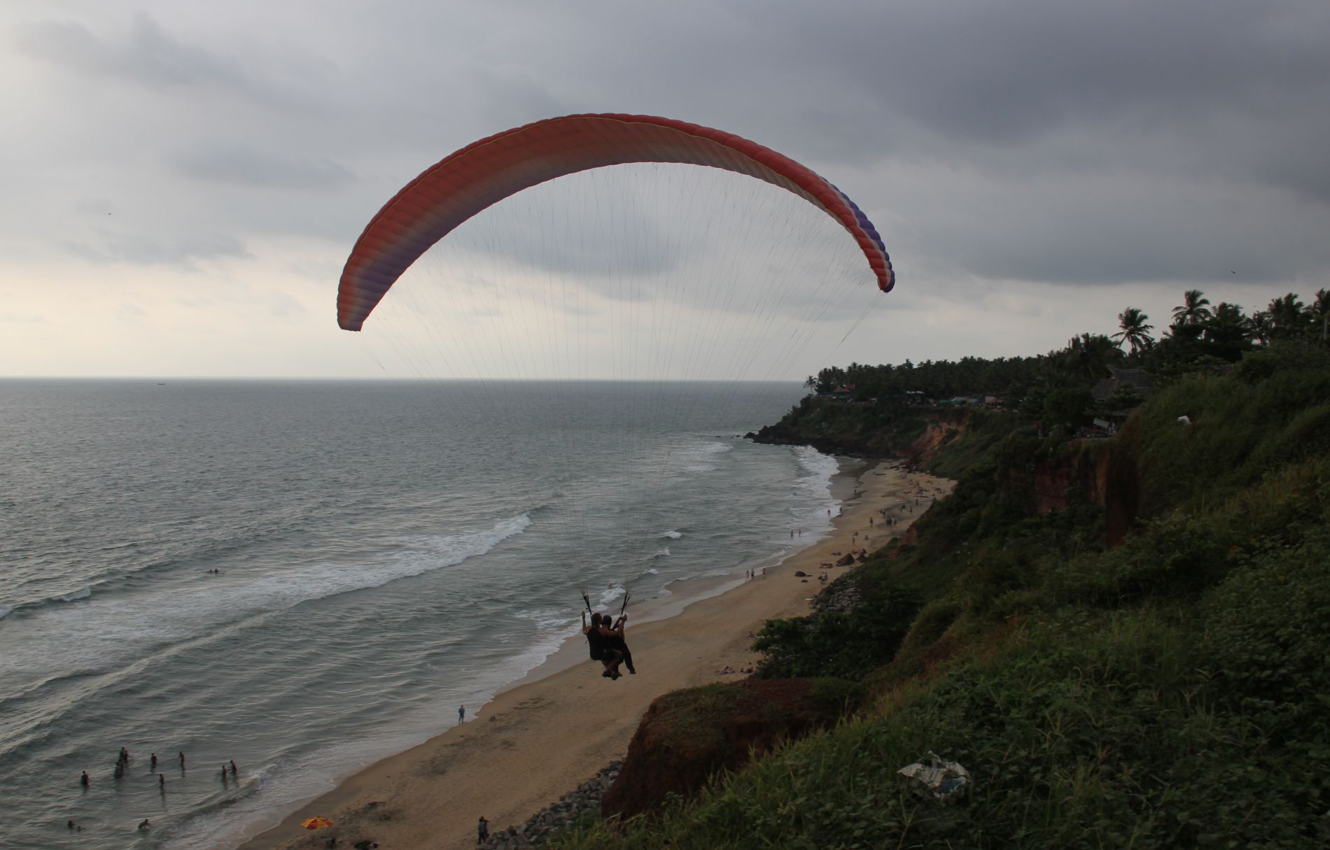 A paraglider takes a tourist flying above the Arabian Sea in Varkala, India.
