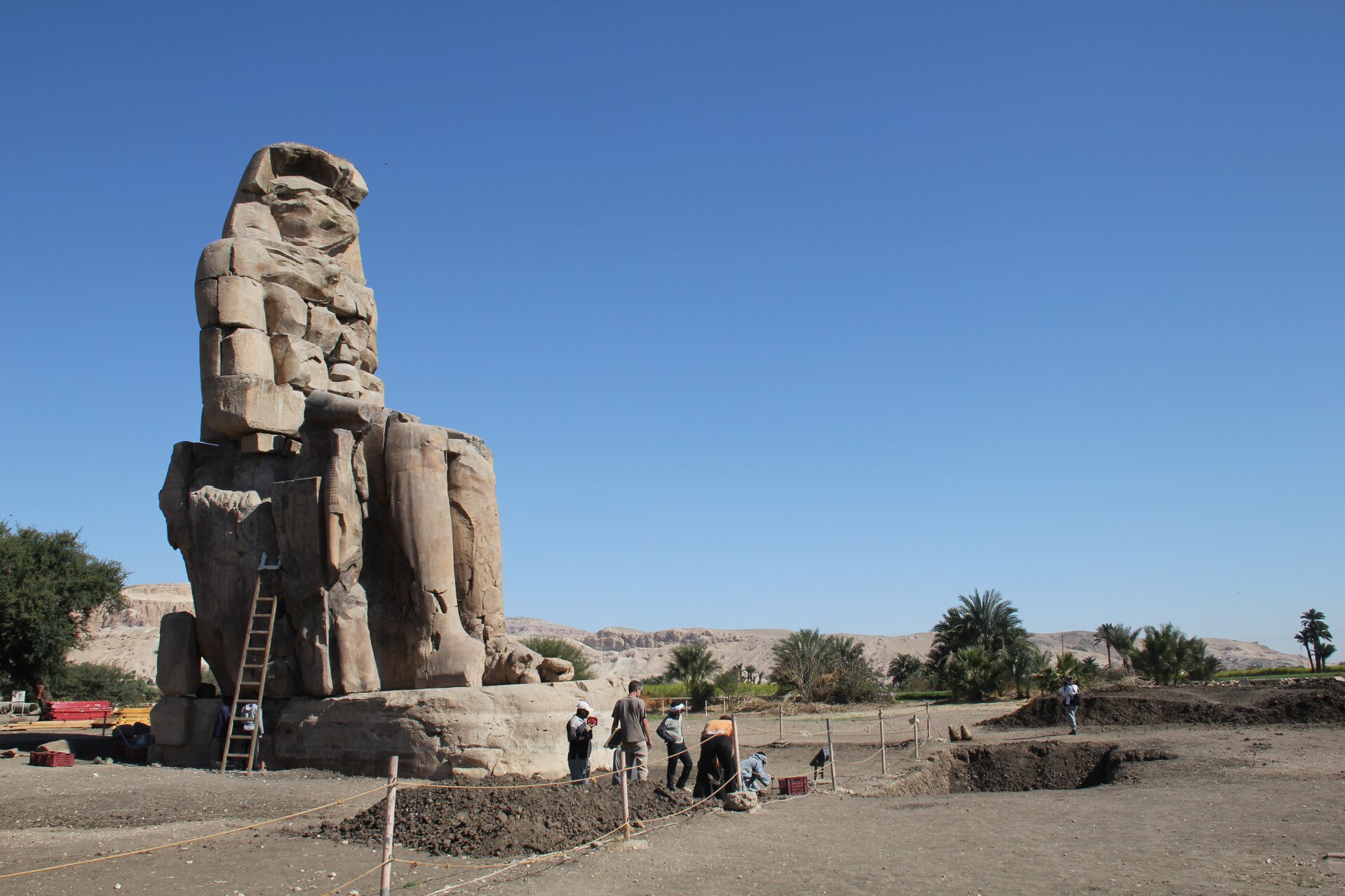 Restorationists work on one of the Colossi of Memnon at the entrance to the Theban Necropolis.