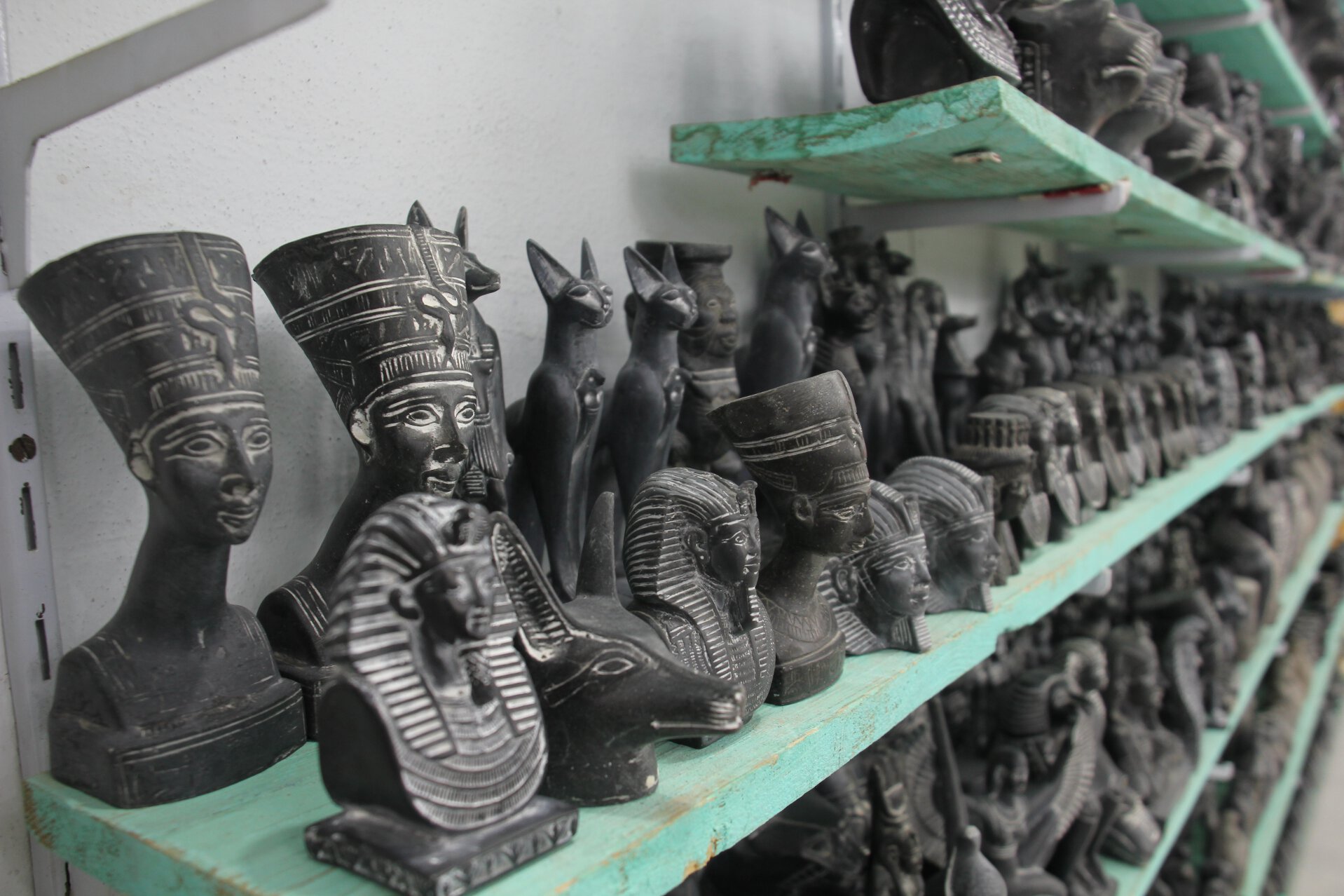 Onyx souvenirs sit on a shelf in an Egyptian gift shop.
