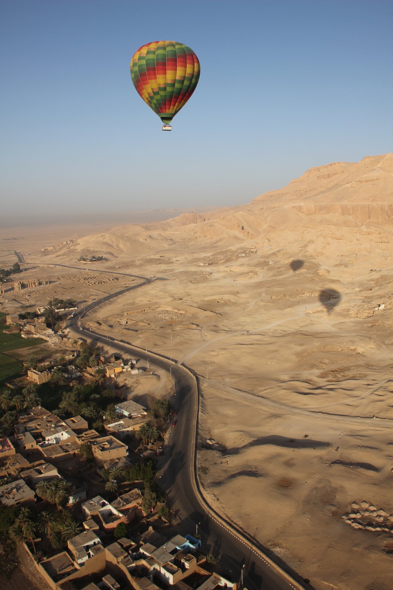 A hot air balloon floats above the Theban Necropolis on the Nile's west bank near Luxor, Egypt.