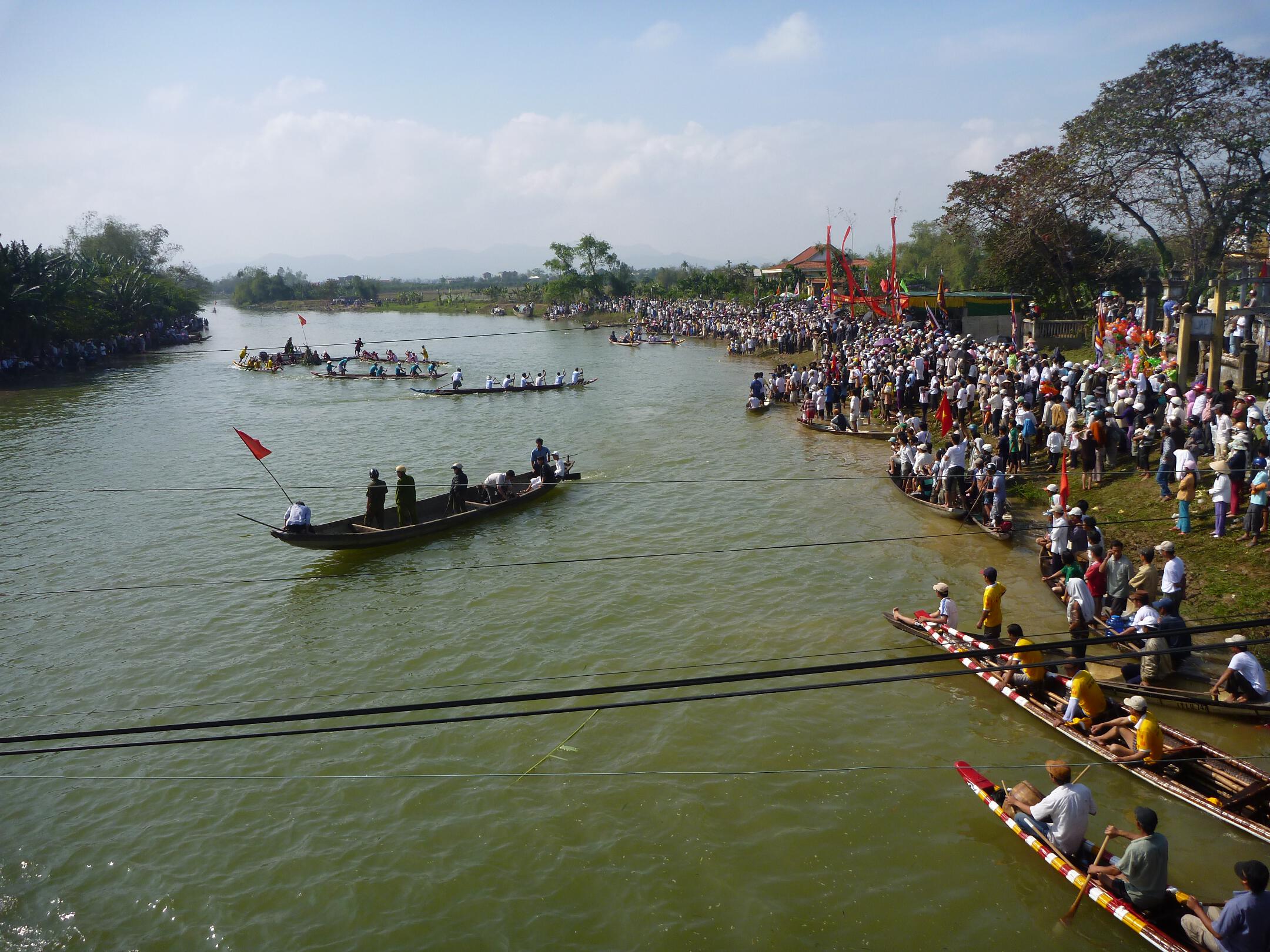 Paddle boats representing nearby towns race against each other on the Perfume River near Hue, Vietnam.