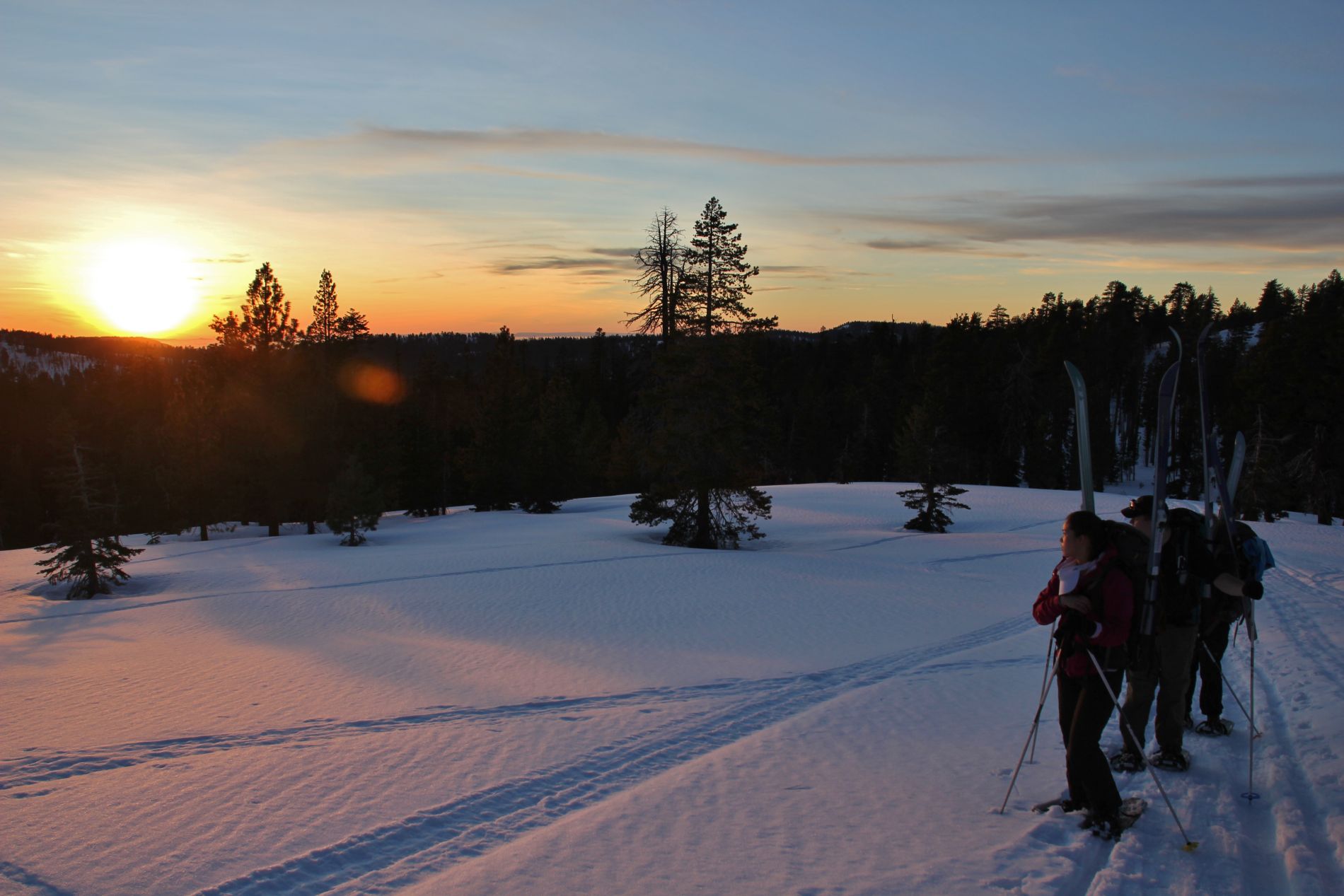 Skiers watch the sunset from Yosemite's Heart Attack Hill.