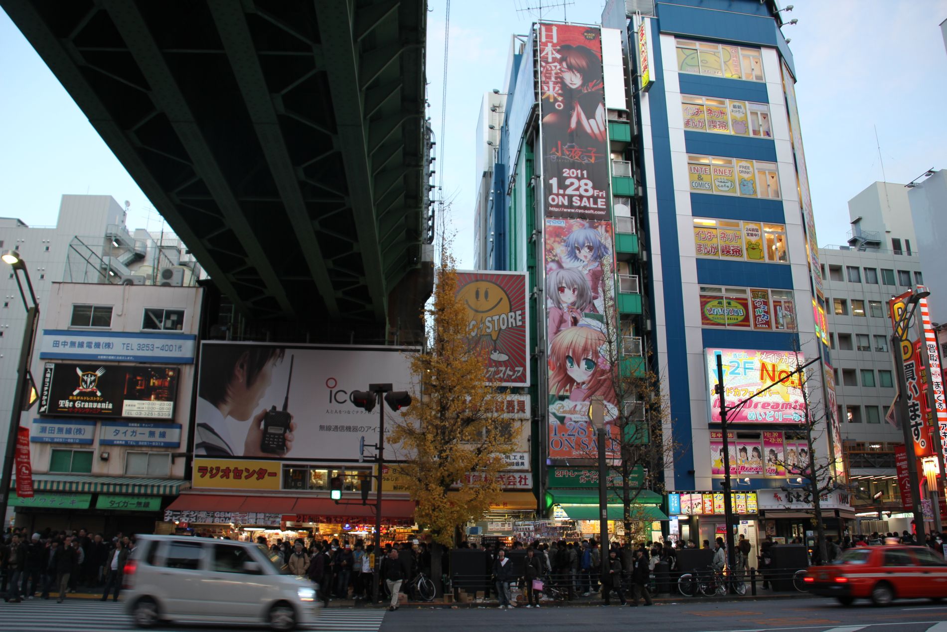 Manga characters overlook a busy street in Akihabara, Tokyo, Japan.