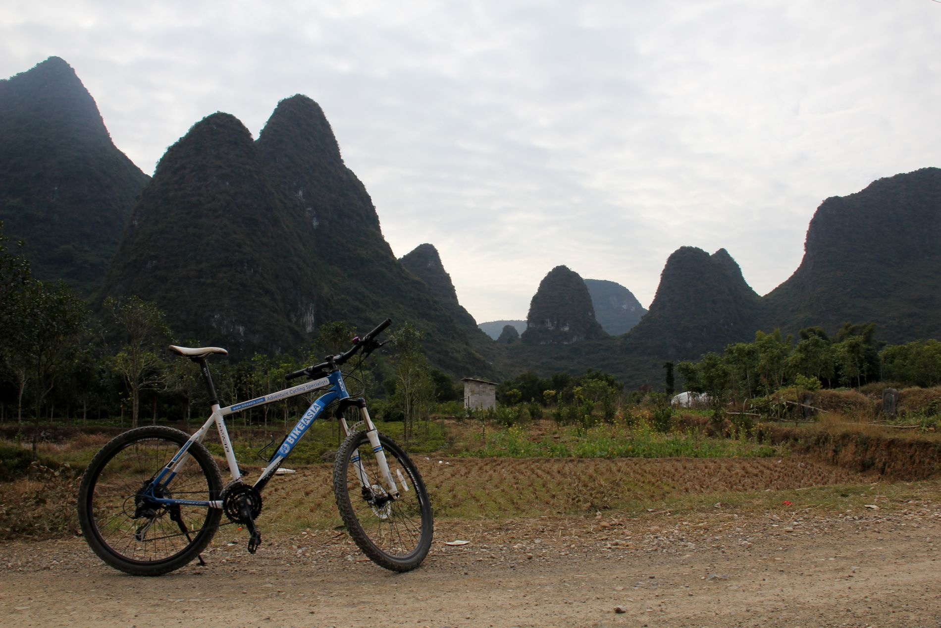 A bicycle sits in front of the otherworldy karsts of Yángshuò, GuÄ?ngxÄ«, China.