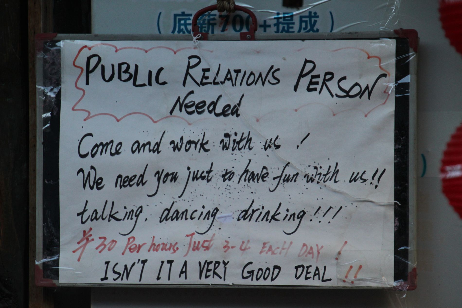 A help-wanted sign hands in DàlÇ?, China.