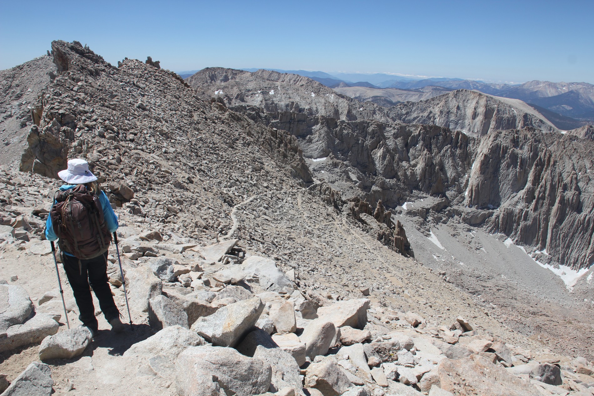A hiker looks at the trail down from the Mount Whitney summit.