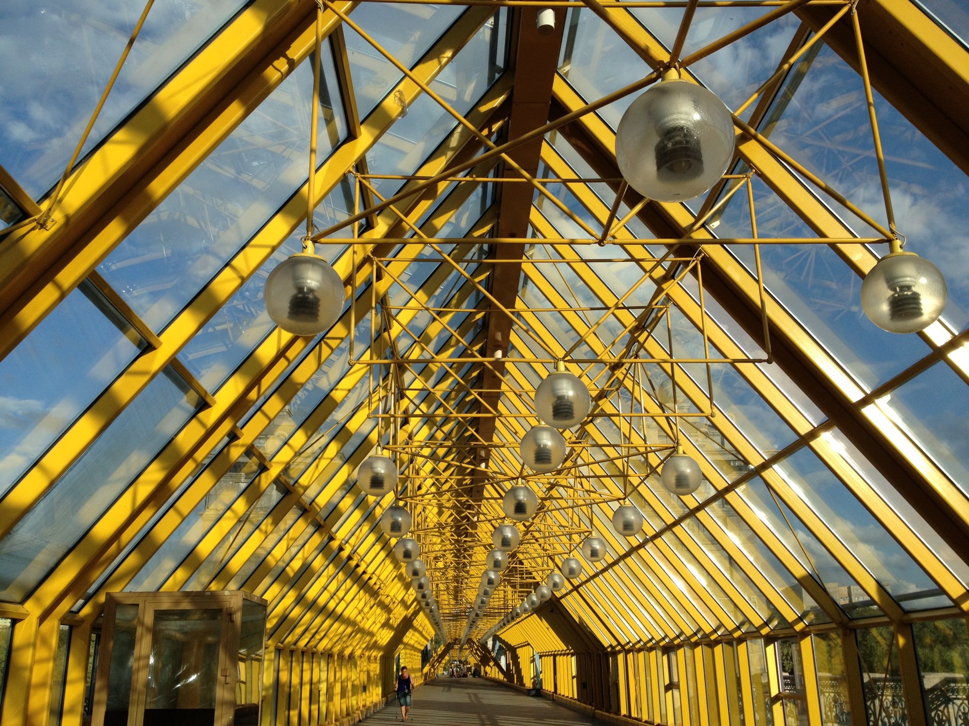 Bright yellow supports and industrial lights cover Andreyevsky (Andrew's) Bridge in Moscow.