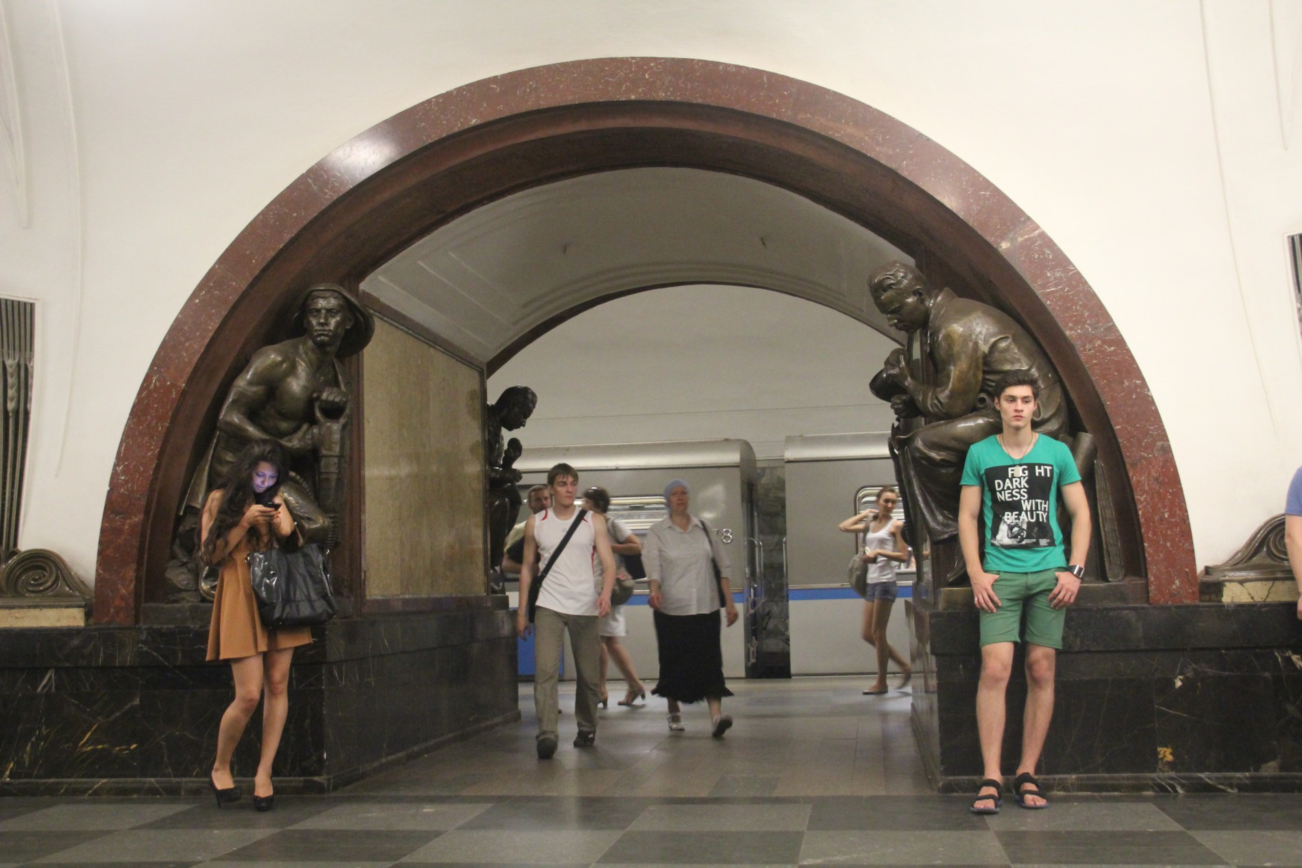 Bronze statues of Russian citizens stand in the Moscow Metro's Ploshchad Revolyutsii Station.