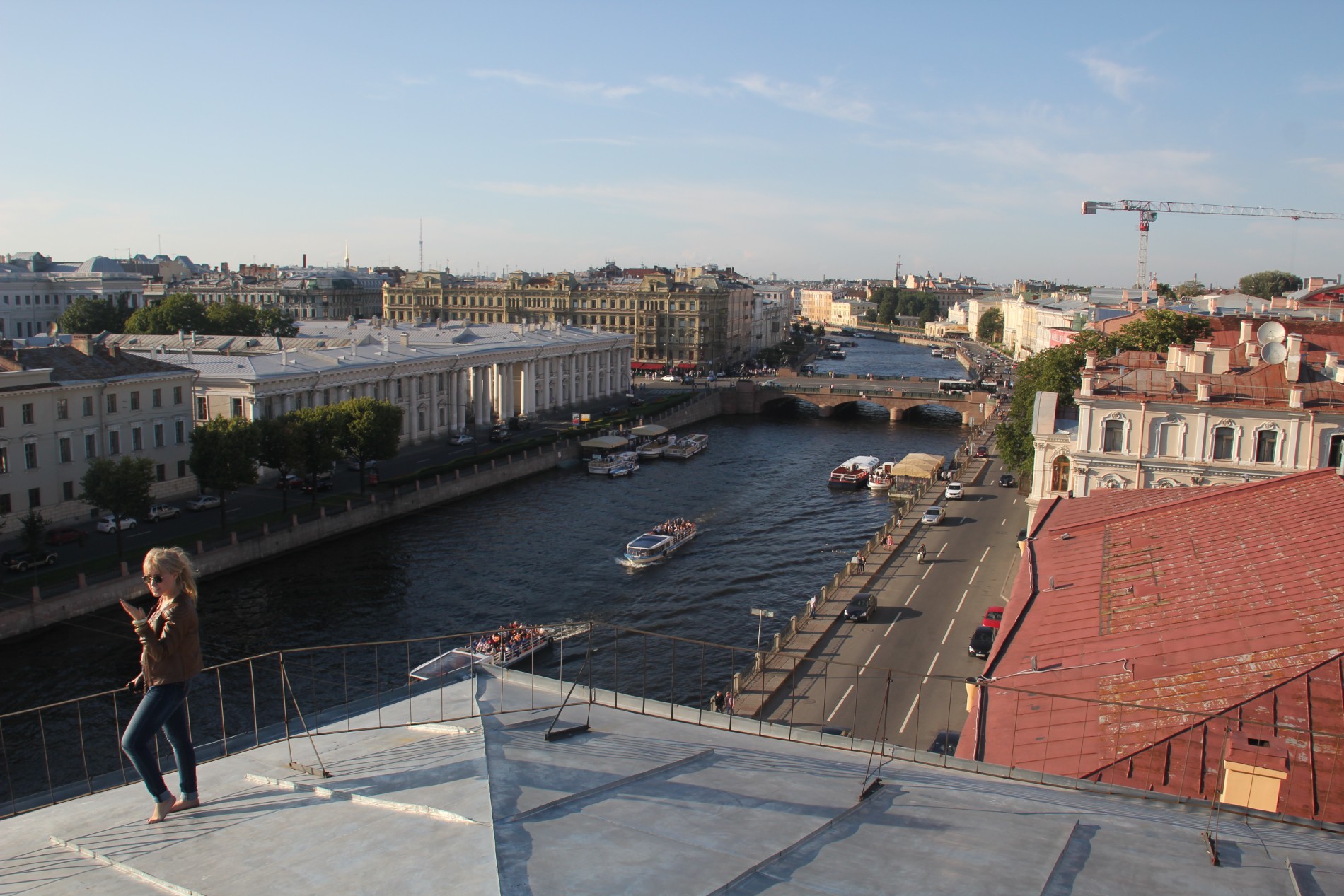 Nastya stands on a roof in St. Petersburg, Russia.