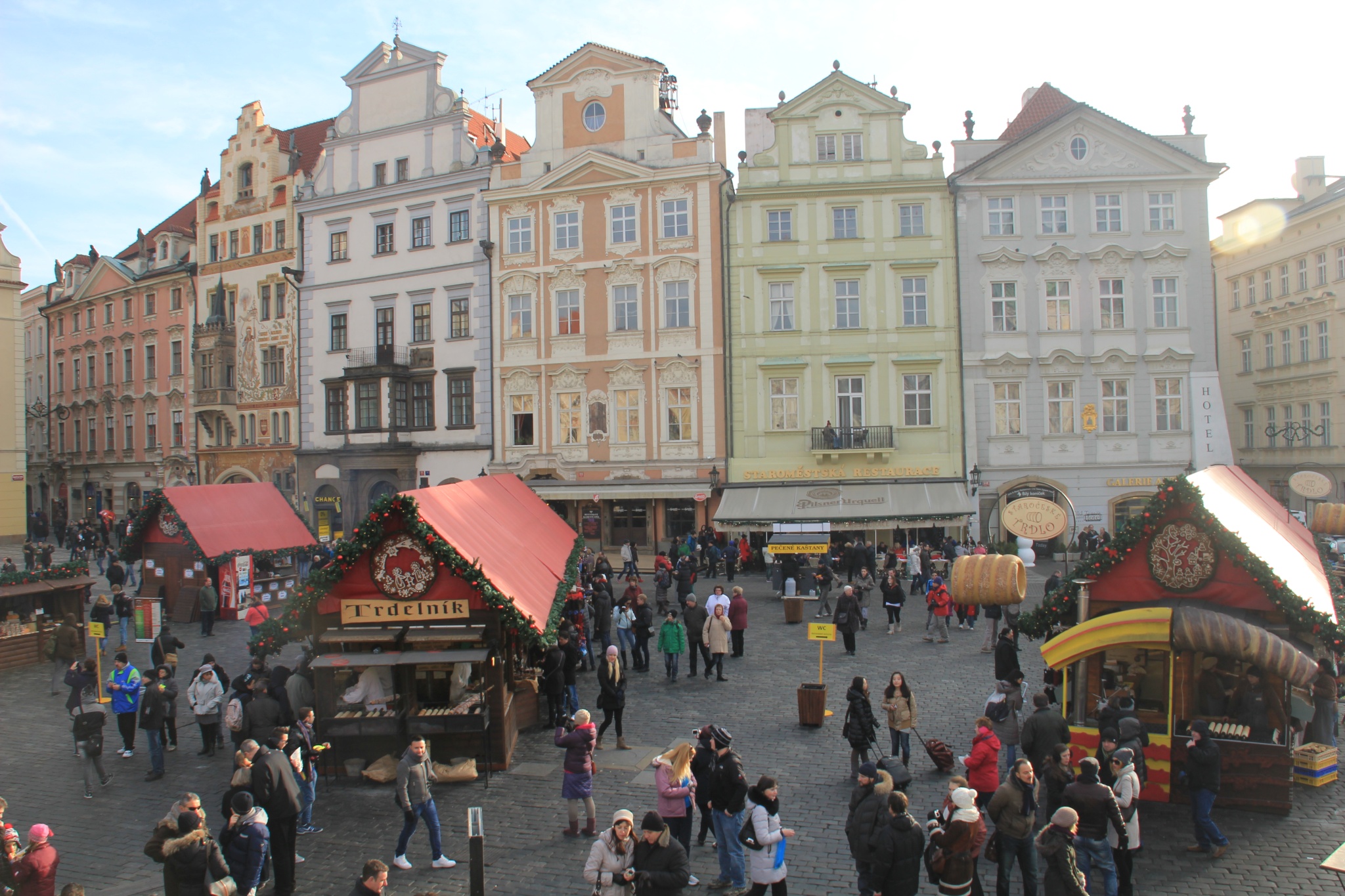 Trdelnik vendors sit in Prague's Old Town Square.