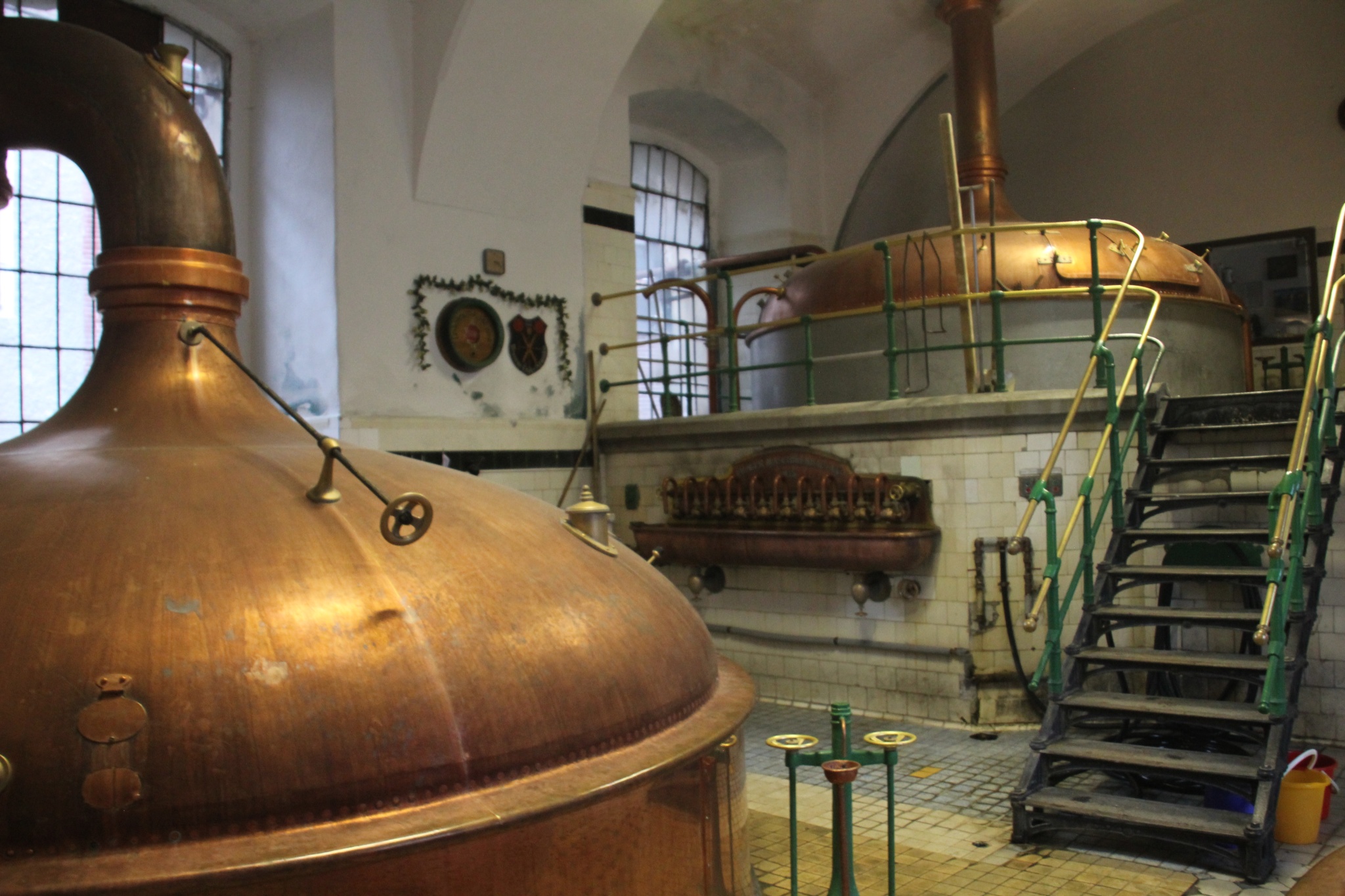 Attractive copper brew kettles sit waiting in the ancient Eggenberg Brewery in Ä?esk&yacute; Krumlov.