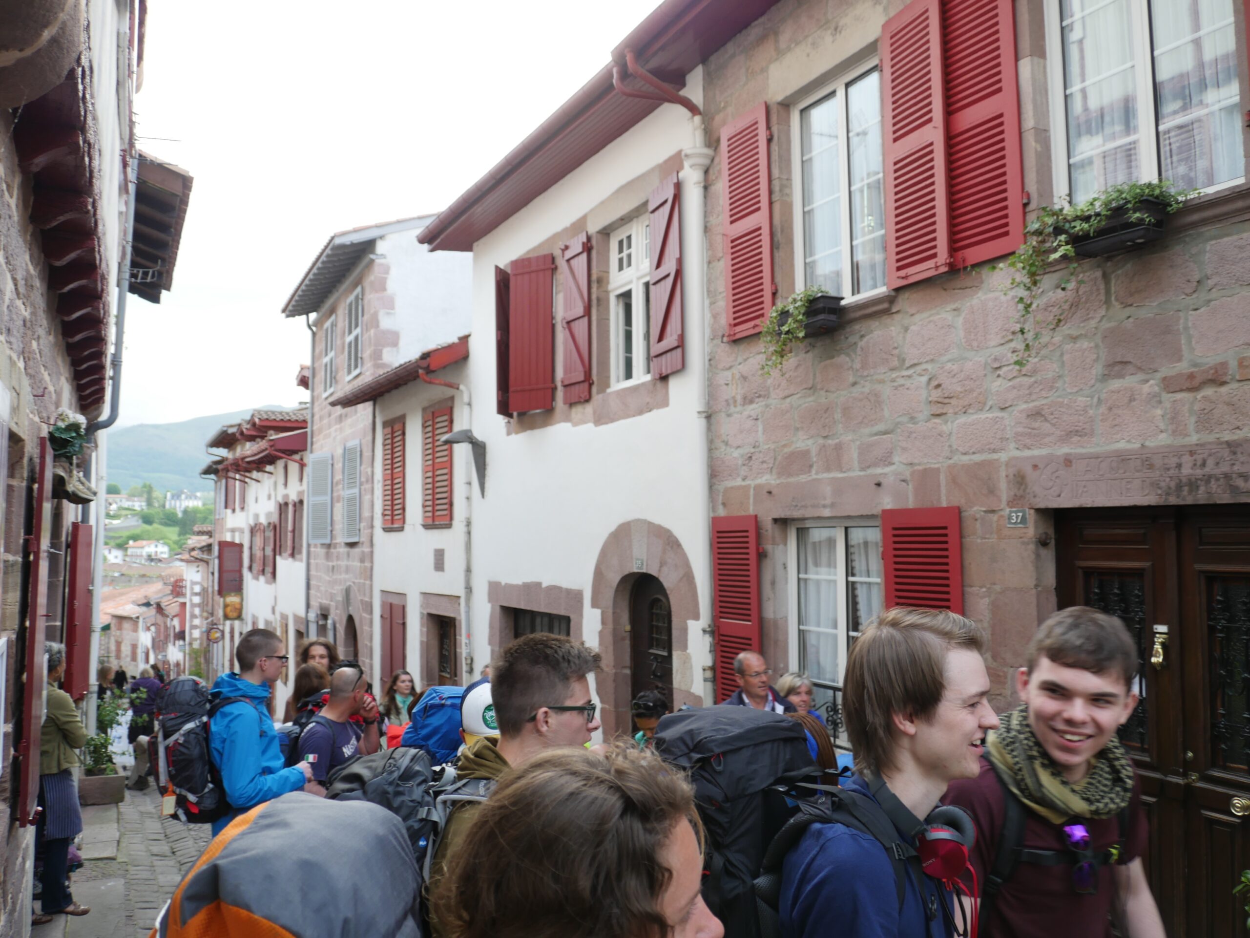 Pilgrims wait in line in Saint-Jean-Pied-de-Port, France to obtain their pilgrim's passport before beginning their trip on the Camino de Santiago.
