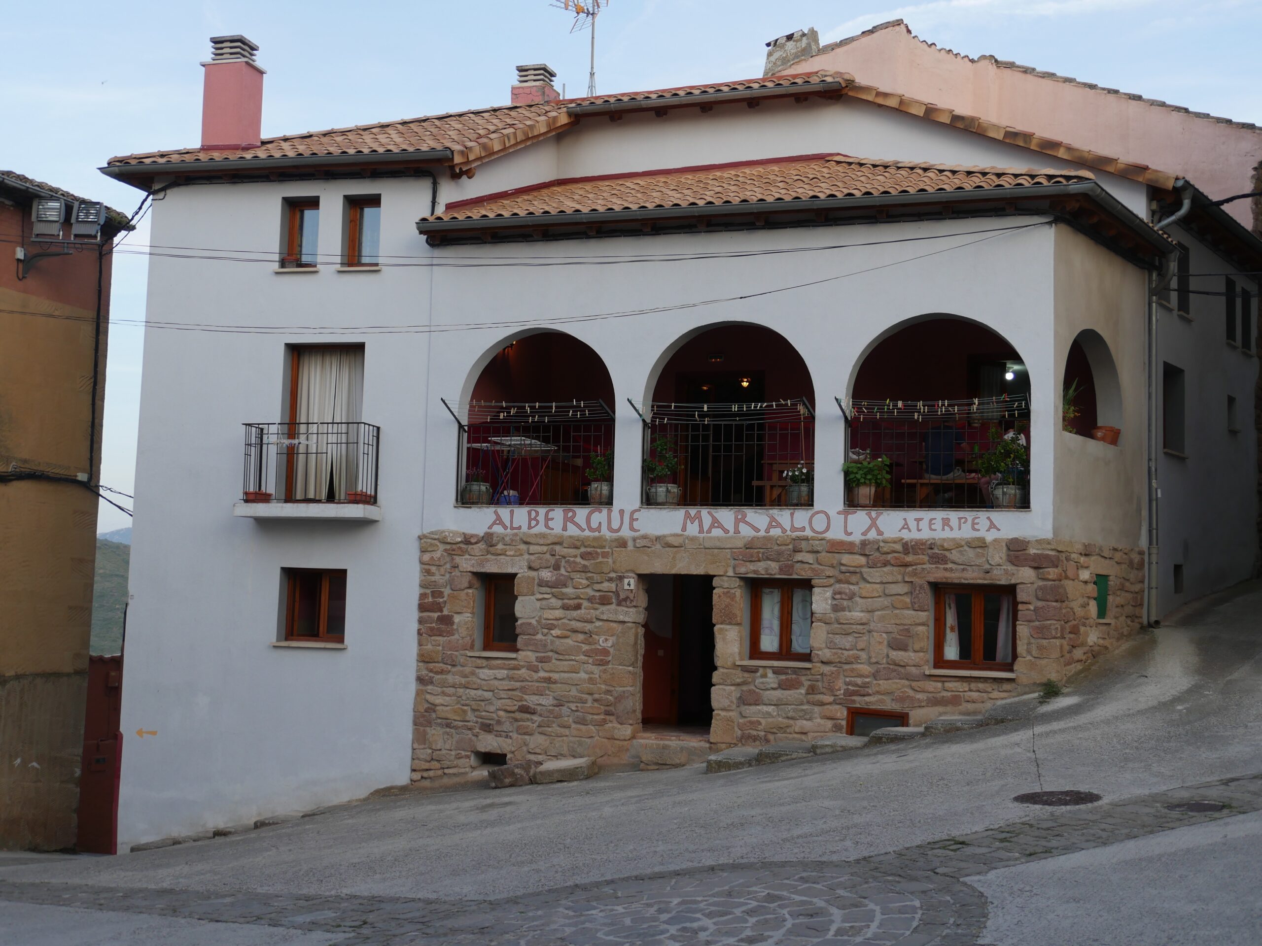 The Maralotx albergue in Cirauqui, Spain has a quaint, elevated patio.