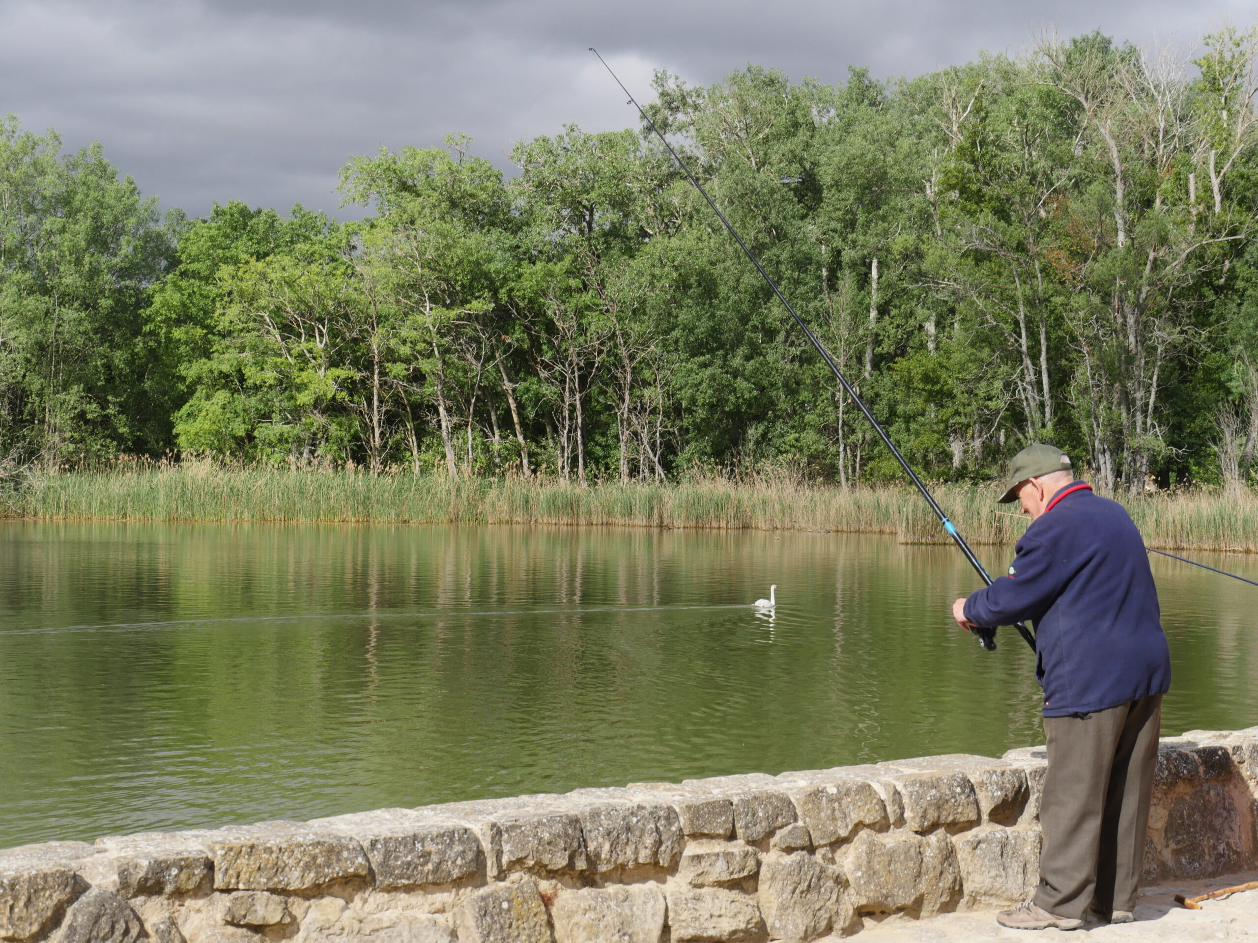 A man fishes in a lake near Logro&ntilde;o, Spain.