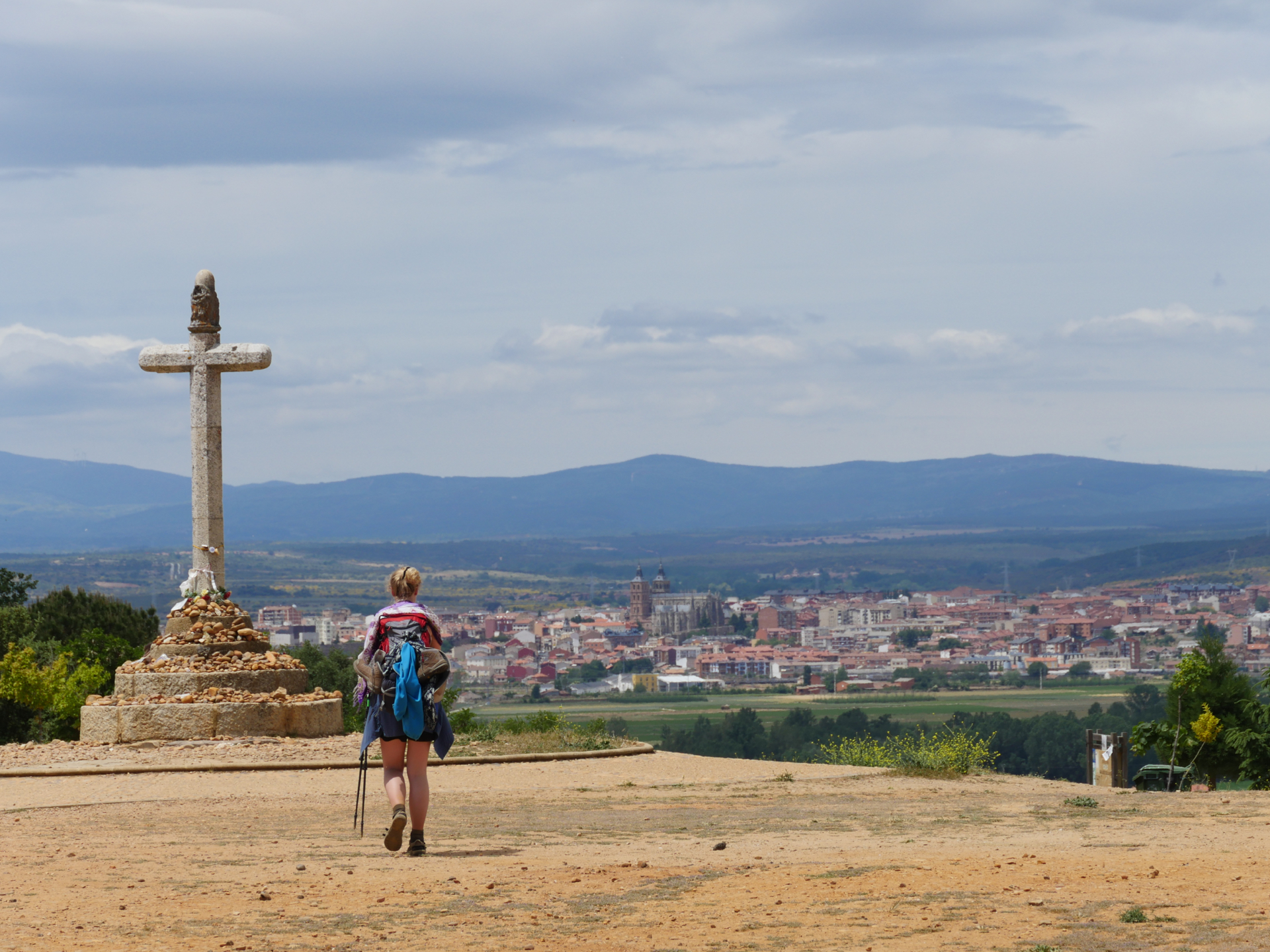 A Camino pilgrim walks toward Crucero de Santo Toribio above Astorga, Spain.