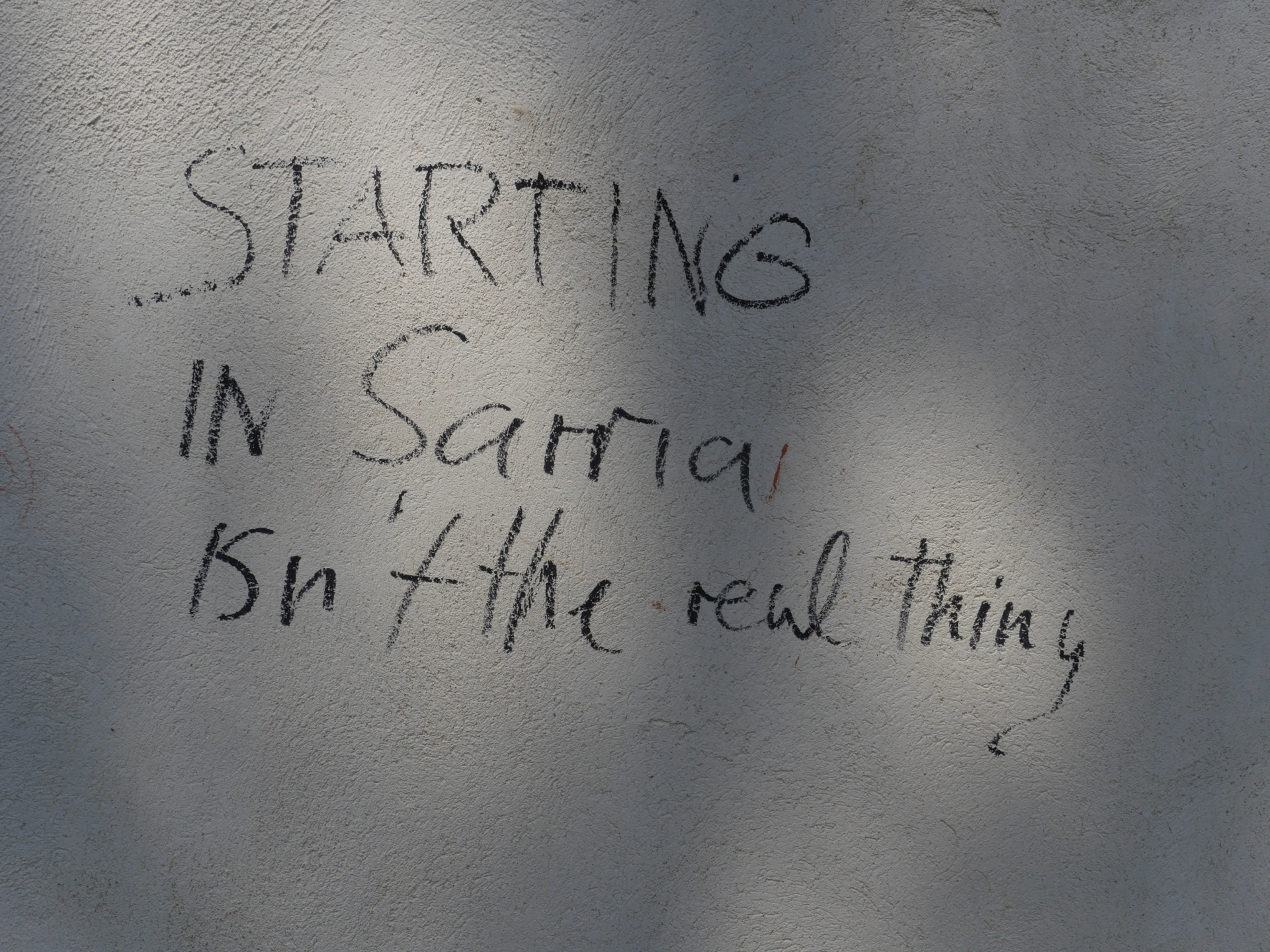 A handwritten sign near Sarria states, "Starting in Sarria isn't the real thing."