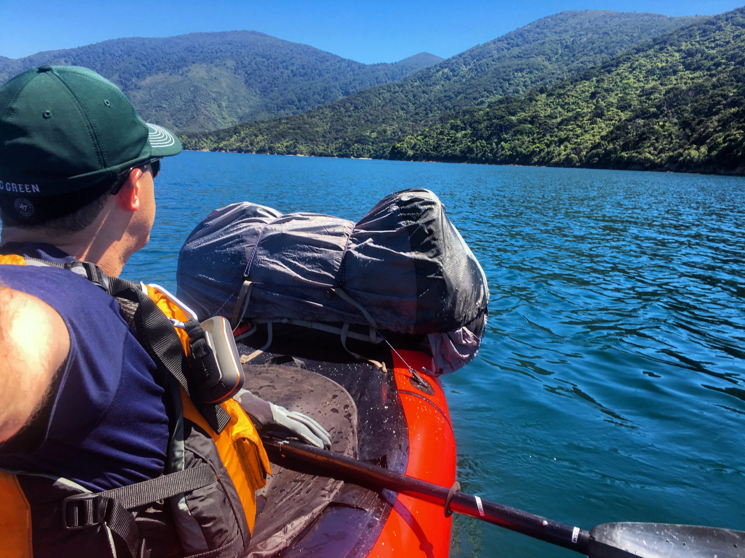 A paddler admires Queen Charlotte Sound, New Zealand from a packraft.