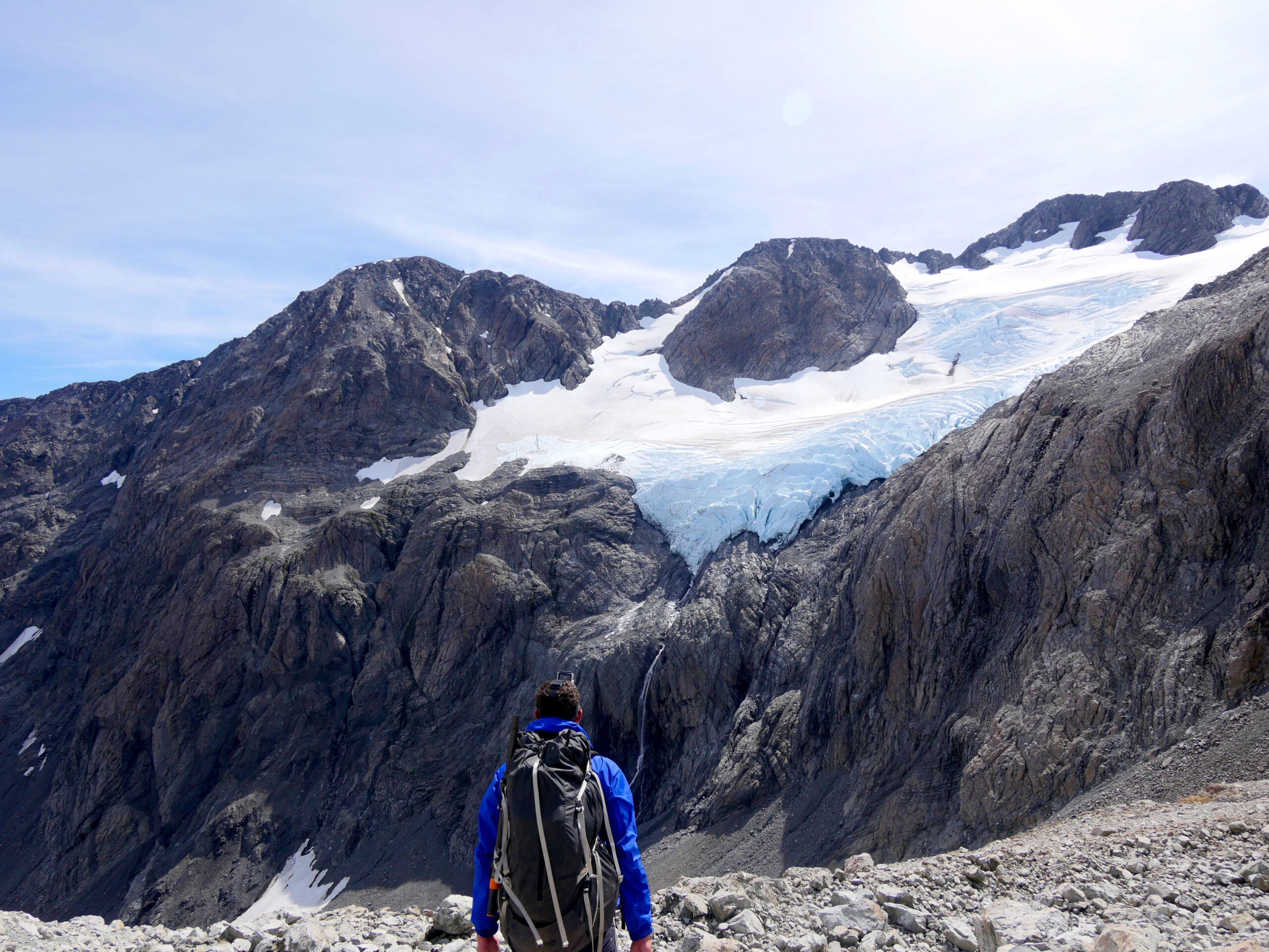 A hiker looks at Cronin Glacier above Whitehorn Pass in Arthur's Pass National Park, New Zealand.