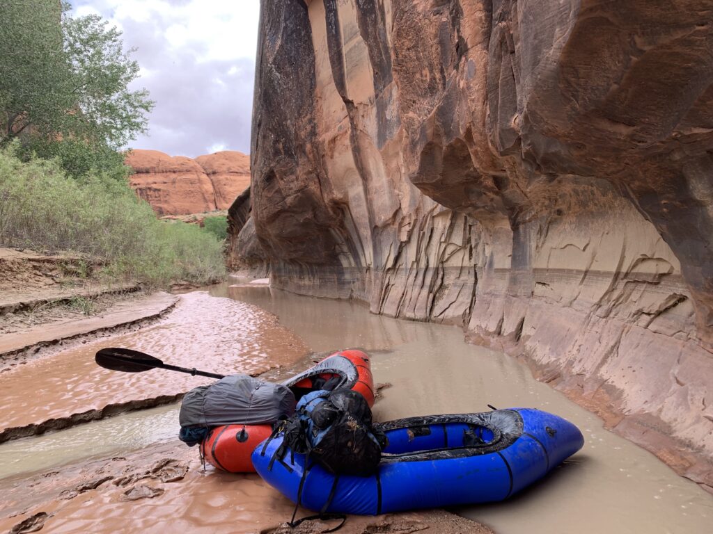 Packrafts sitting near a side-canyon confluence with the Escalante River